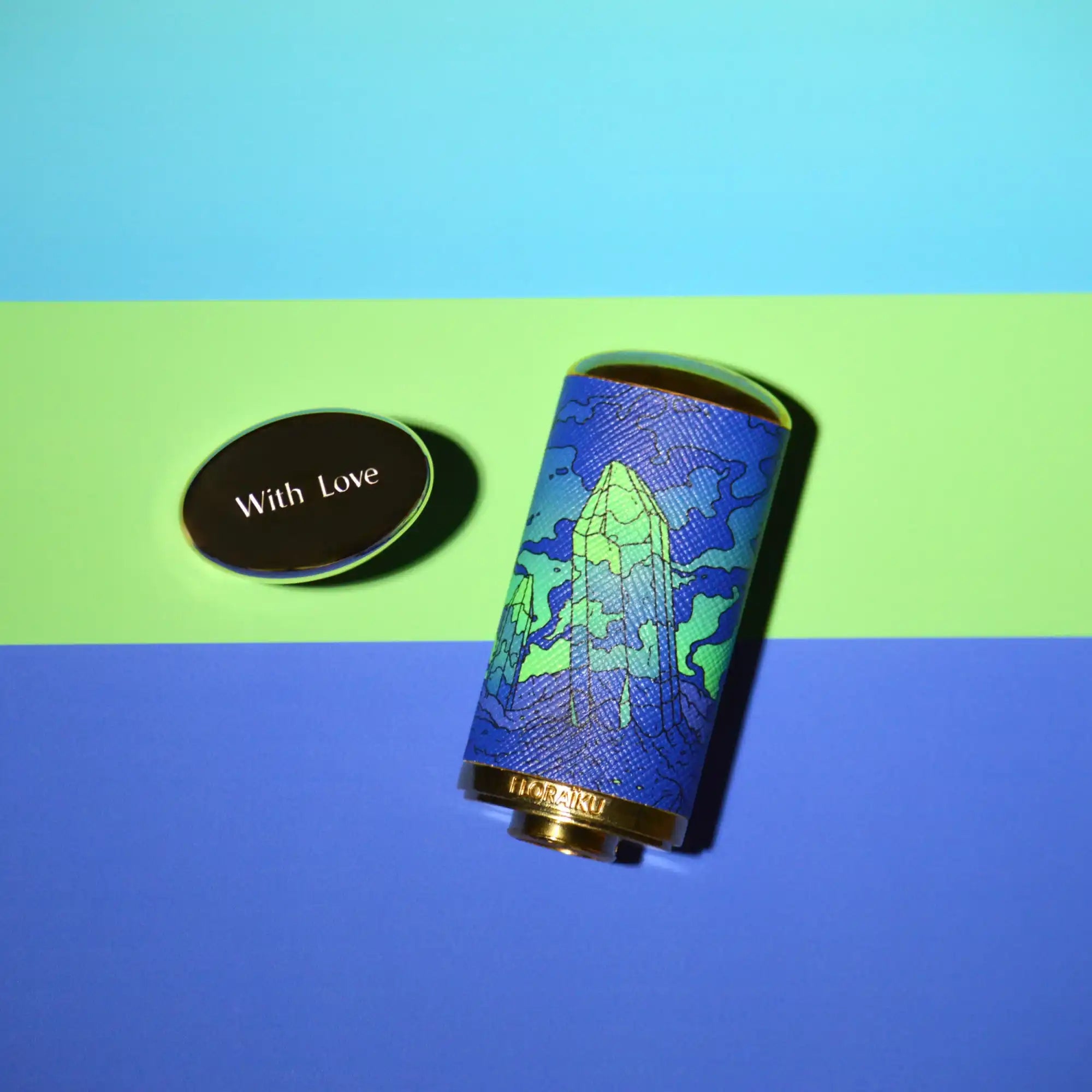 Blue cylindrical device with a rocket ship artwork design.